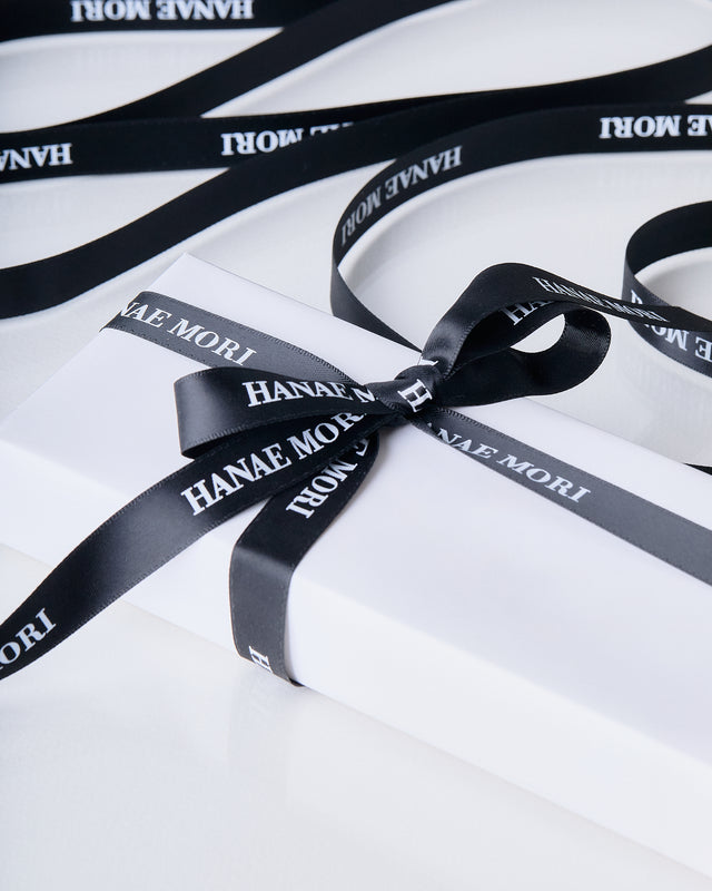 Parfums Hanae Mori Our Services Your products are meticulously wrapped by our team in elegant satin gift paper, dressed in white and adorned with a black ribbon featuring the Hanae Mori logo. Enjoy a touch of luxury with our beautifully presented gift packaging.